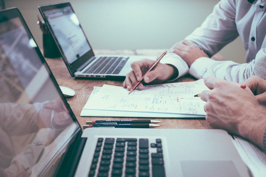 Klovent consultants planning outcome-focused IT with notes and a laptop