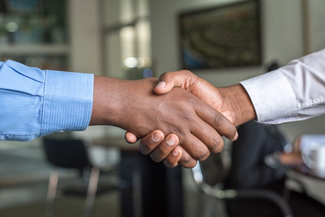 A Klovent engineer shaking hands with a client